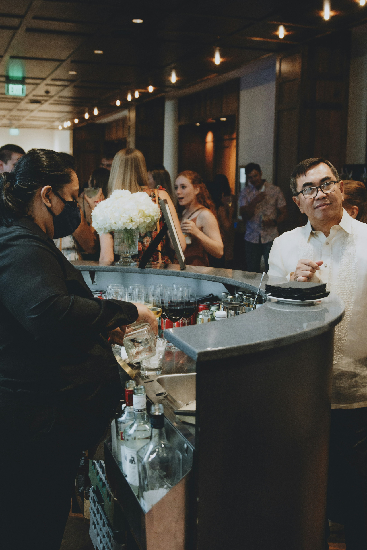 Bartender pouring drinks at a Posies Bar event